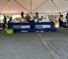 Staff standing at the AHA's table.