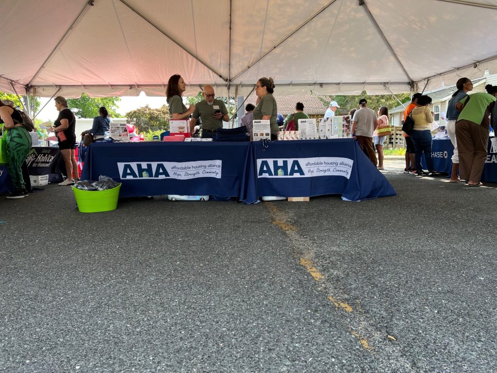 Staff standing at the AHA's table.